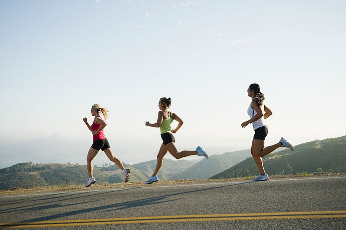 Runners training on side of a road